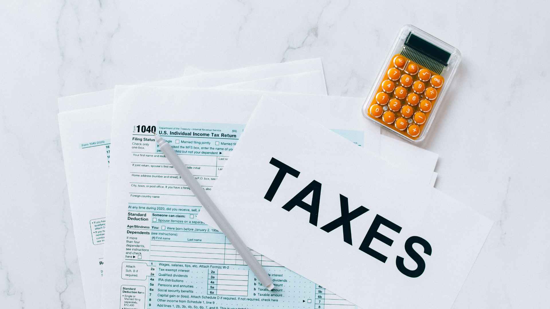 a calculator sitting on top of a tax form